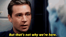 a man says " but that 's not why we 're here " in yellow letters