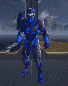 a man in a blue and black armor is giving the thumbs up
