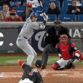 a baseball player with the number 7 on his jersey swings at a ball