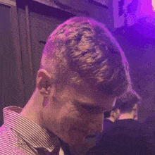 a man in front of a sign that says lola x