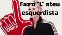 a woman in a black jacket is giving a thumbs up with a red foam finger .