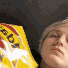 a close up of a person holding a bag of tortilla chips