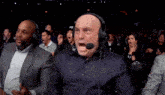 a man wearing a headset with the letter p on it screams