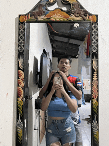 a man and woman are taking a picture in a mirror