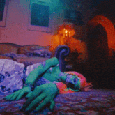 a person is laying on a bed with a couch and a lamp in the background