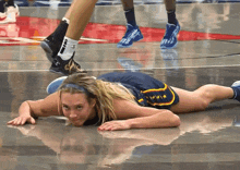 a female basketball player is laying on the floor and her shorts say ' chicago ' on them