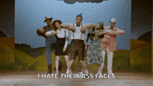 a group of people dancing on a stage with the words i hate their ass faces