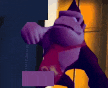 a purple gorilla wearing a red shirt that says ok on it