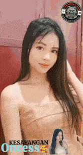 a woman in a strapless dress with the word kesayangan oncess on the bottom