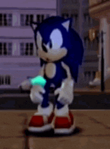 sonic the hedgehog is standing on a sidewalk in front of a building holding a green object .