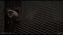 a person is breaking through a glass door in a movie scene .