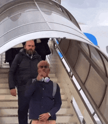 a man wearing headphones is walking up the stairs