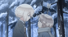 a boy and a girl are looking at each other in a forest