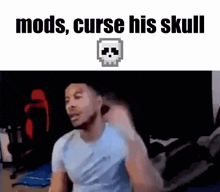 a man is sitting in front of a computer with a skull in the background and the words `` mods curse his skull '' .
