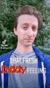 a man is wearing a blue jacket with the words that fresh diddy feeling written on it