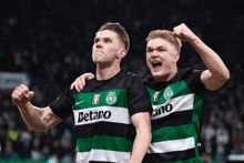 two soccer players with betano on their shirts