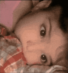 a close up of a baby 's face looking at the camera