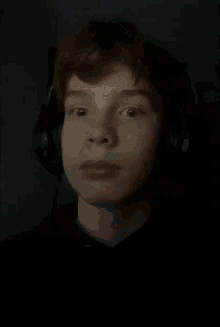 a close up of a person 's face with a hand on it