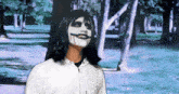 a person wearing a white hoodie with a joker face paint on their face