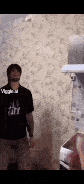 a man in a ny t-shirt is standing in a kitchen