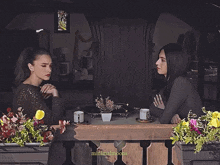 two women sit at a table with minimalmoons written on the bottom right