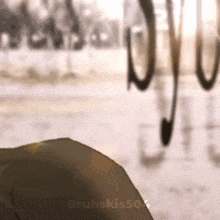 a close up of a person standing in front of a window with a bicycle in the background .