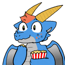a blue dragon with horns is holding a striped container of popcorn