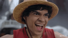 a man wearing a straw hat and a red shirt with netflix on the bottom right