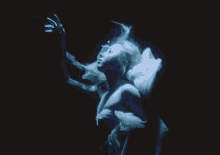 a woman in a white dress is floating in the dark