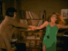 a man and a woman are dancing in a room