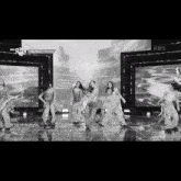a black and white photo of a group of dancers on a stage