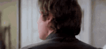 a close up of a man 's back in a room .