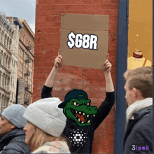 a person holding a sign that says $ g8r