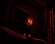 a pumpkin with a face carved into it looks out of a dark room