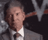 a close up of a man 's face in a suit and tie looking at the camera .
