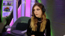 a woman wearing headphones and a necklace that says ' xm ' on it