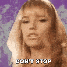 a woman is making a funny face and saying `` don 't stop '' .