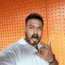 a man with a beard is giving a thumbs up