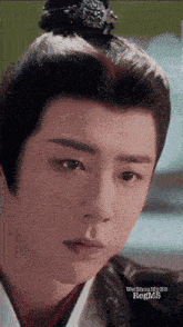 a close up of a man 's face with regms written on the bottom right
