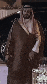 a man with a beard wearing a long brown robe