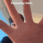 a close up of a person 's hand covering their face .