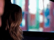 a woman is looking out the window of a car