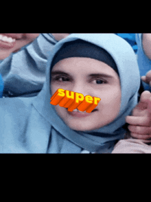 a woman in a hijab has the word super on her nose