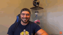 a man wearing a hat with the letter r on it is smiling