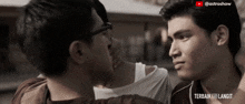 two men are looking at each other in a video that says " terbaik ke langit "