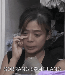 a woman is crying in a closet with the words sobrang sakit lang on the bottom