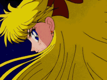 a close up of a girl 's face with long blonde hair