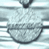 a close up of a necklace with a circle shaped pendant on it