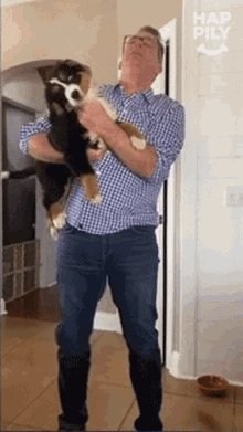 a man is holding a puppy in his arms with hap pily written on the bottom