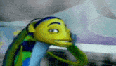 a close up of a cartoon fish with headphones on looking at the camera .
